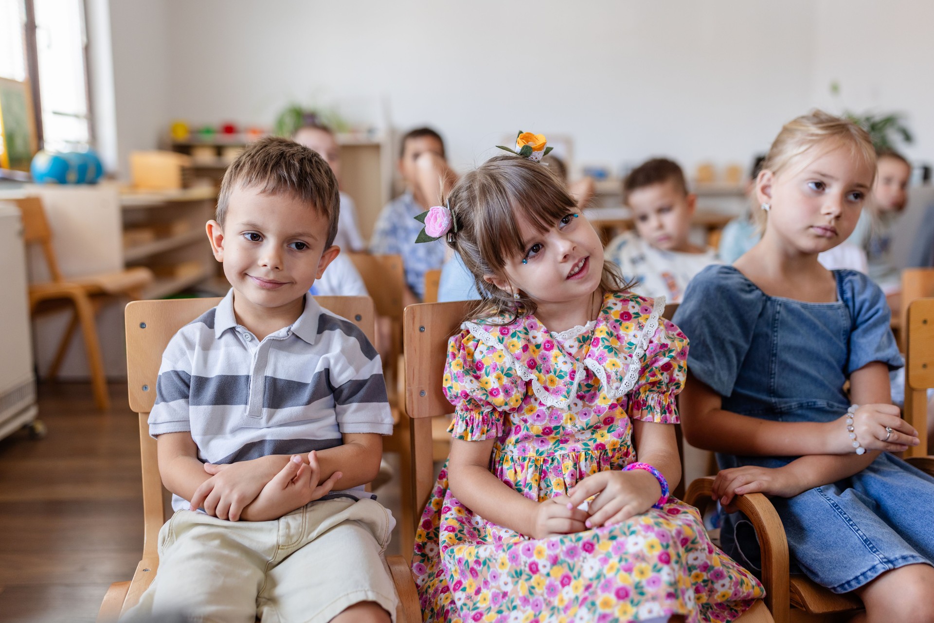 Children sit attentively during classroom music activity